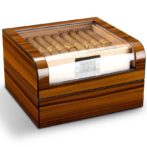 Wooden cigar humidor with a glass lid, cigars lined up inside, and a digital humidity display on the front.