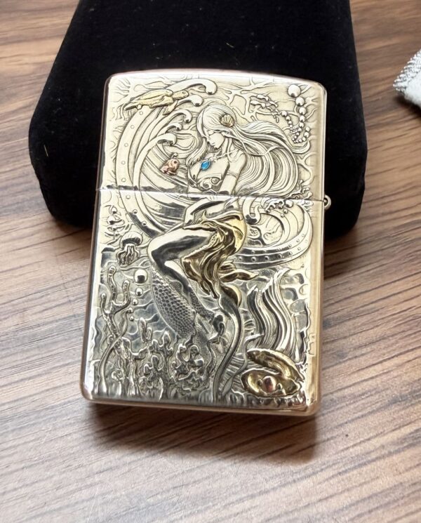 KZ003_02 Brass Zippo lighter with an engraved mermaid among waves and sea creatures, a blue gem at her chest.