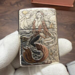 Warm-color mermaid artwork on the sterling silver Zippo Armor lighter