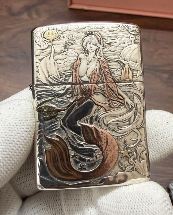 KZ003_06 Engraved Zippo lighter featuring a mermaid with flowing hair and a seashell backdrop, sea life etched around her.