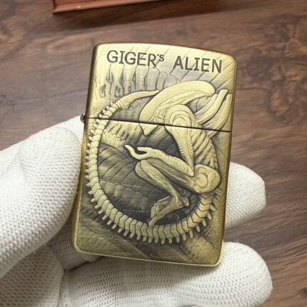 Brushed-brass Zippo Armor lighter with engraved H. R. Giger Alien artwork