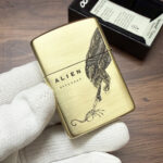 Front Alien figure on the H. R. Giger brushed-brass Zippo Armor lighter