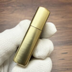 Angled front view of the brushed-brass biomechanical Alien design