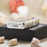 White Tara silver-and-gold Zippo Armor lighter displayed with Zippo packaging