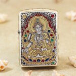 Silver-plated Zippo Armor lighter with engraved White Tara artwork and gold inlay