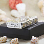 Nine-Tailed Fox silver-and-gold Zippo Armor lighter displayed with Zippo packaging