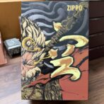 Zippo branded box featuring bold fantasy artwork with a horned armored warrior wielding a flaming sword against a dark red background