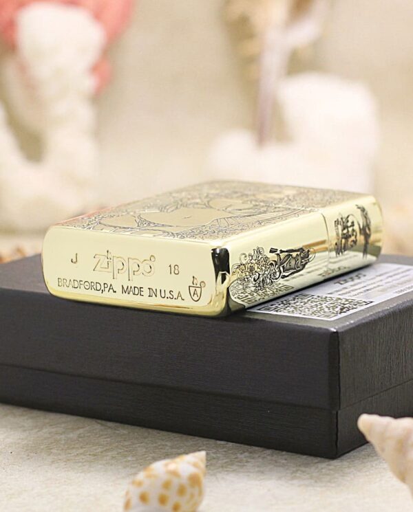 KZ365-05 Gold Zippo lighter resting on a black gift box, with decorative engravings and text like 'Zippo' and 'Made in USA' visible.