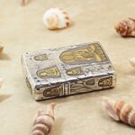 Gold-tone accents within the silver grotto Buddha design