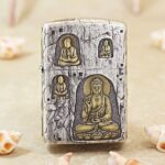 Silver-plated Zippo Armor lighter with grotto Buddha engraving and gold accents