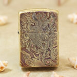 High-polish brass Zippo Armor lighter with engraved legendary phoenix