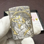 Hinge-side view of the engraved Guanyin Armor lighter