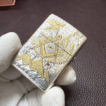 Hinge-side detail on the engraved Egyptian-themed Zippo Armor lighter