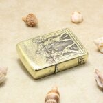 Deep engraved detail across the Egyptian-themed brass Armor lighter