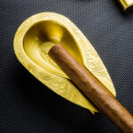 LUBINSKI LB-TZ-6 antique brass single-cigar ashtray holding a cigar