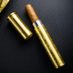 LUBINSKI LB-TZ-6 antique brass single-cigar tube with cigar partially inserted