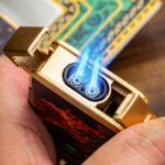 Close-up of LUBINSKI YJA-80035 dual-jet cigar lighter producing two blue flames