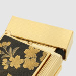 S.T. Dupont C16151 Maki-e Ryusui Shunju lighter close-up of gold textured cap and lacquer artwork