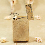 Karl Wieden KW-T0293B open petrol lighter showing wick-style mechanism and gold auspicious symbol design