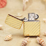 Zippo Armor gold-tone diagonal stripe lighter open showing windproof insert