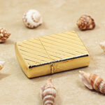 Zippo Armor gold-tone diagonal stripe lighter lying flat showing textured bands