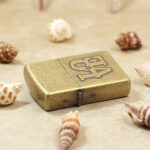 Zippo Classic LOVE lighter lying flat showing antique brass-tone finish