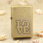 Zippo Classic antique brass-tone LOVE lighter front view
