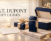 Navy and gold patterned lighter beside a luxury gift box and ribbon